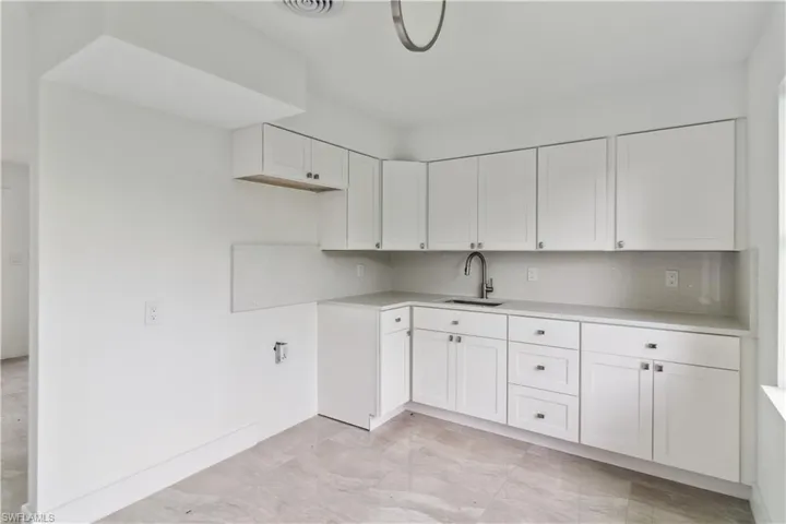 Kitchen featuring sink and white cabinetry