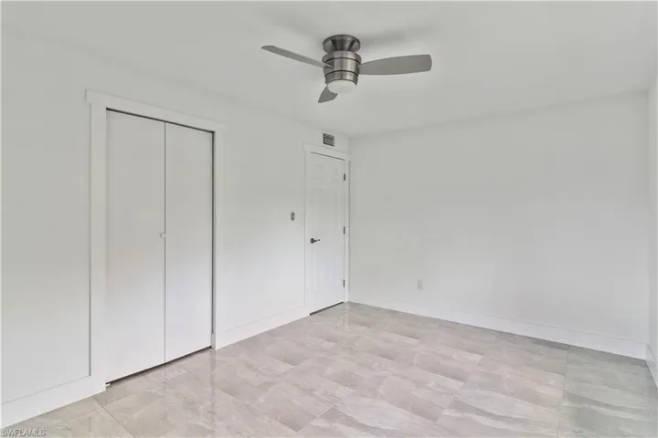 Unfurnished bedroom featuring ceiling fan and a closet