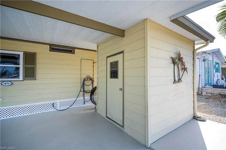 Storage shed just outside with newer washer and dryer