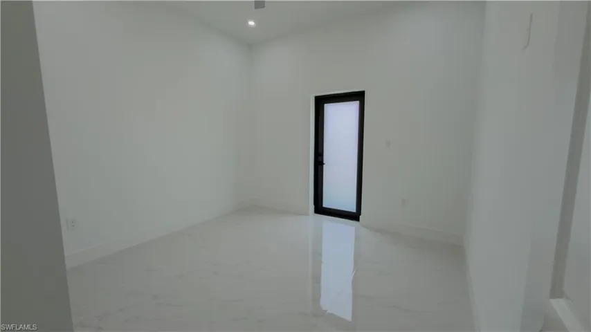 Spare room featuring light marble finish flooring and recessed lighting