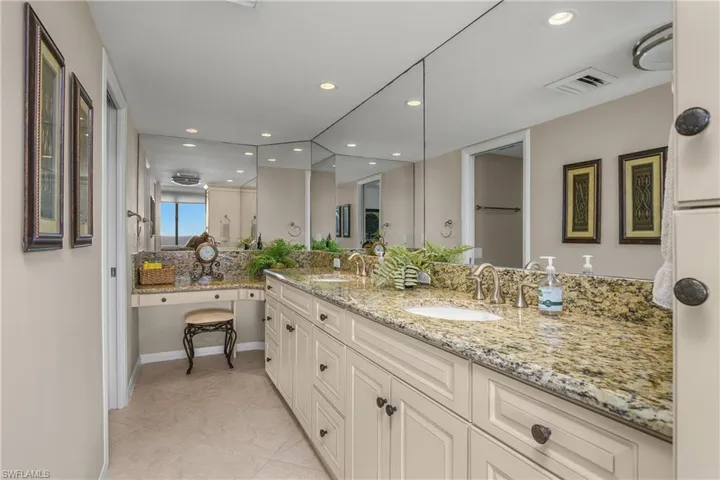 Master bathroom with double vanity, recessed lighting, light tile patterned floors, and backsplash