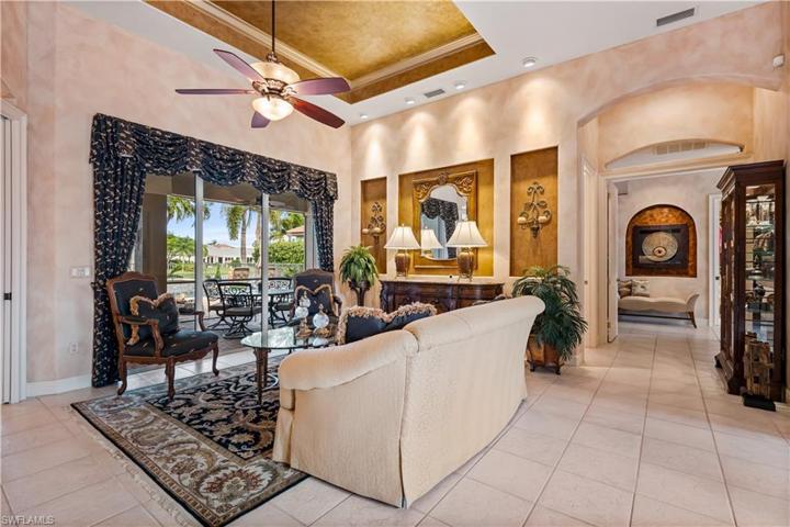 As you enter into this fabulous home, this is 1 of 2 living spaces this home has to offer with breathtaking views of the lake! Tray ceilings.Custom niches, custom faux painting, archways!