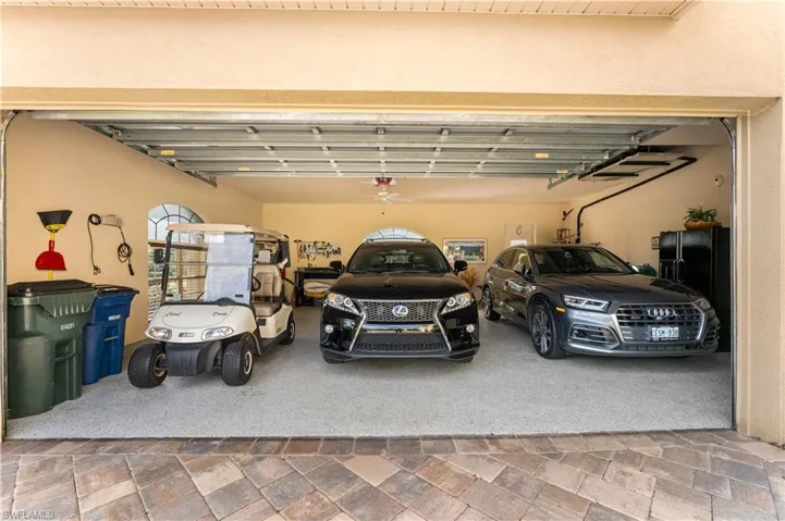 This garage can accommodate 2 cars and a golf cart! The floor has an epoxy finish.