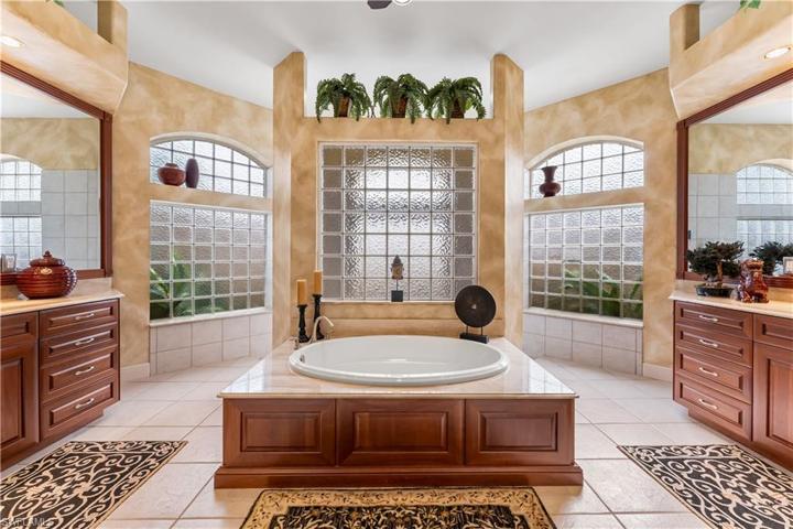 Ensuite primary bath has separate comfort height granite countertops, soaking tub, walk thru shower. Amazing amount of natural light comes through all of these glass brick windows!