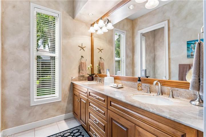 2nd full bathroom offers comfort height dual granite countertop vanities.