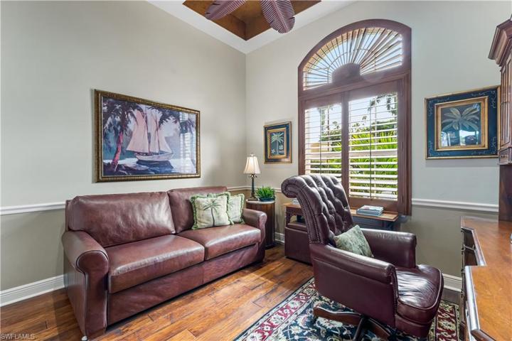The 4th bedroom has hand scraped wood floors, coffered ceilings, custom plantation shutters, chair railing and is set up as an office at this time.