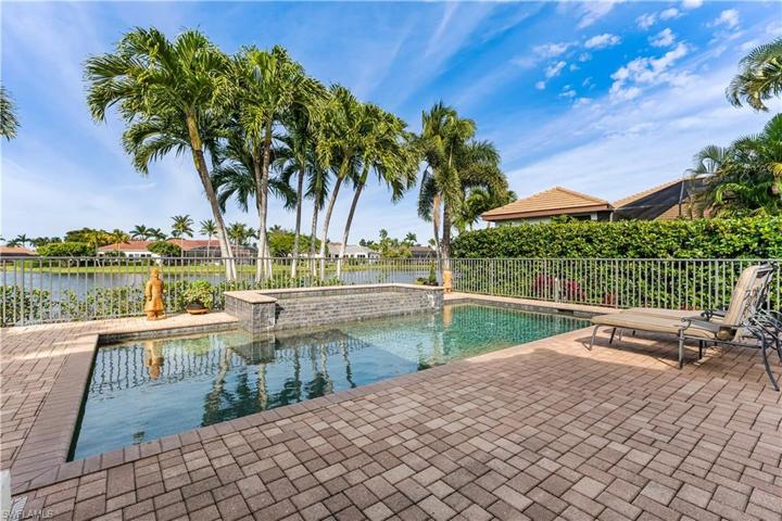 Heated swimming pool/spa has a waterfall, views of the lake, pavered pool deck.