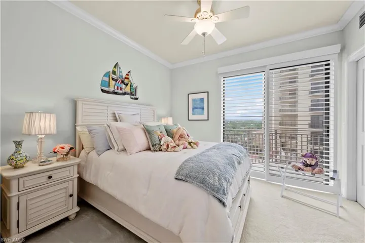 Bedroom featuring light carpet, access to exterior, ornamental molding, and a ceiling fan