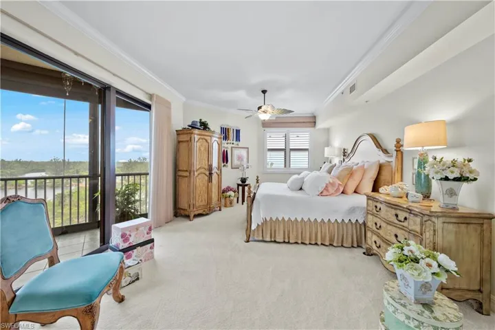 Bedroom with access to outside, ornamental molding, light colored carpet, and ceiling fan