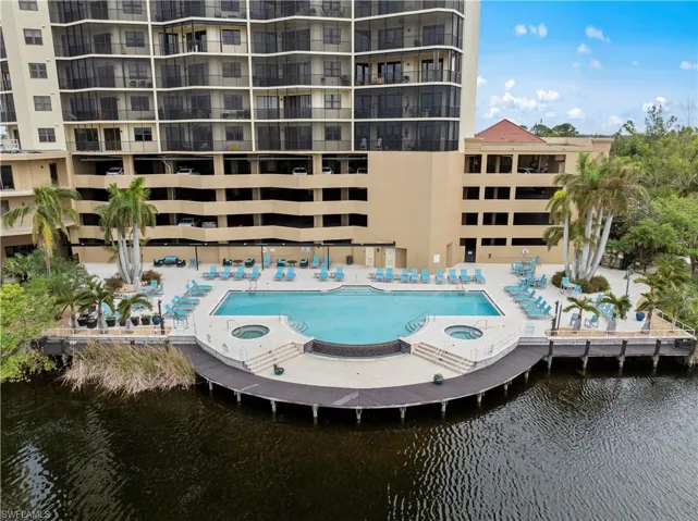Community pool featuring a community hot tub and a water view