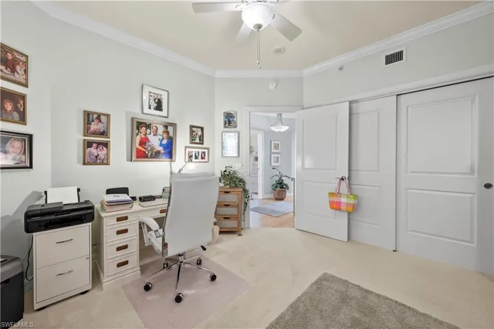 Office featuring crown molding, ceiling fan, and light carpet