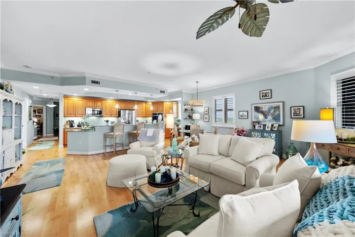 Living room with crown molding, light wood-type flooring, and recessed lighting