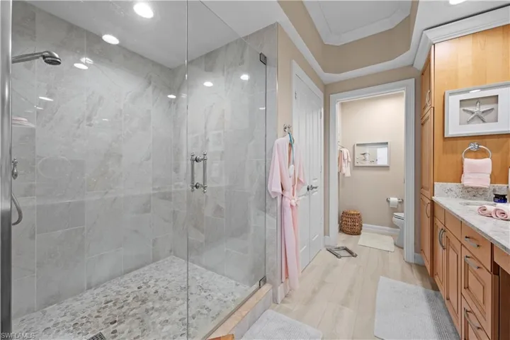 Full bathroom with a shower stall and vanity