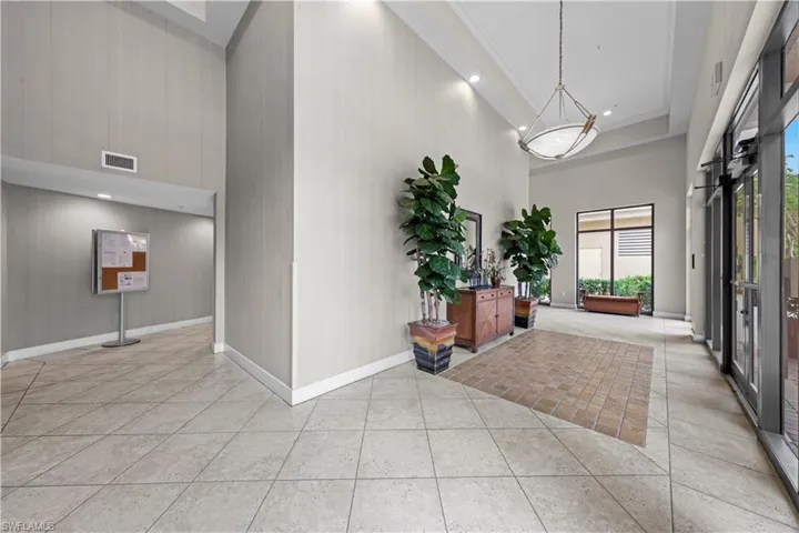 Entrance foyer featuring a high ceiling, light tile patterned flooring, and recessed lighting