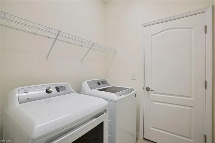 Laundry room featuring washer and clothes dryer
