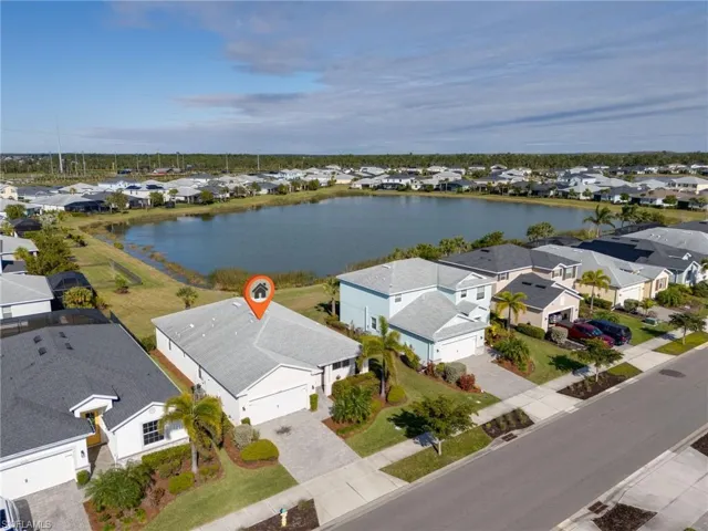 Birds eye view of property with a water view