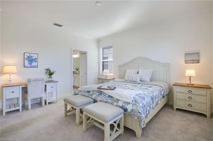 Owners bedroom featuring crown molding and ensuite bath