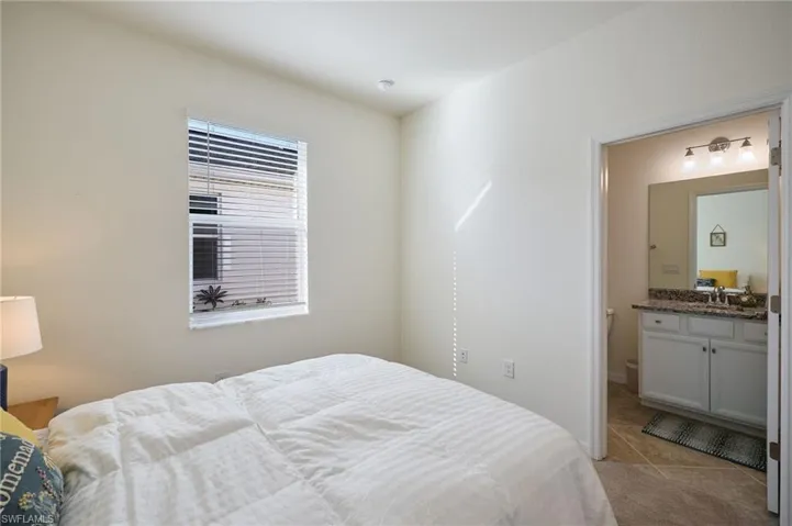 Bedroom with sink and light tile patterned floors