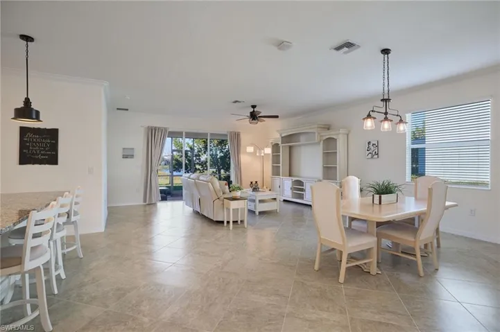 Dining area with crown molding and ceiling fan