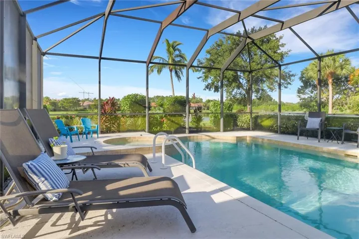 Outdoor pool featuring a patio area, an in-ground hot tub, and a lanai