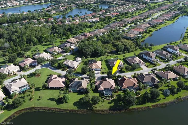 Aerial view of property's location featuring nearby suburban area and a nearby body of water