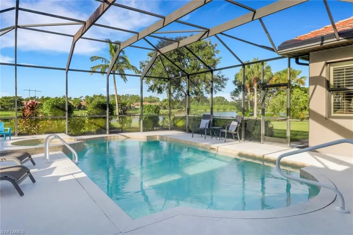 Swimming pool with a patio area, a hot tub, and a lanai