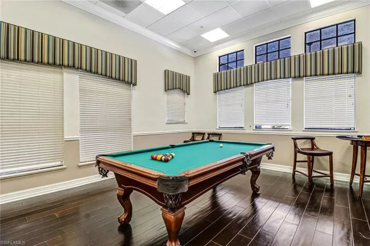 Game room with crown molding, hardwood / wood-style flooring, and billiards table
