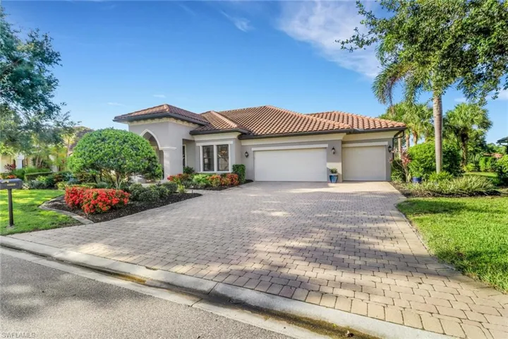 Mediterranean / spanish home with an attached garage, stucco siding, decorative driveway, and a tile roof