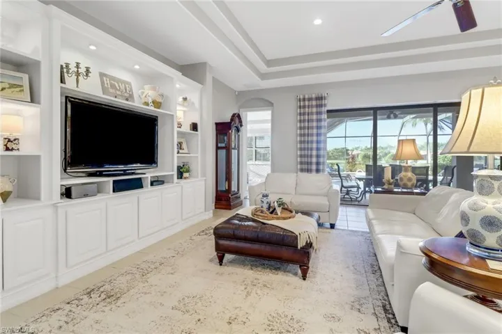 Tiled living area with built in shelves and recessed lighting