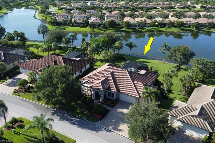 Aerial view of residential area featuring a large body of water