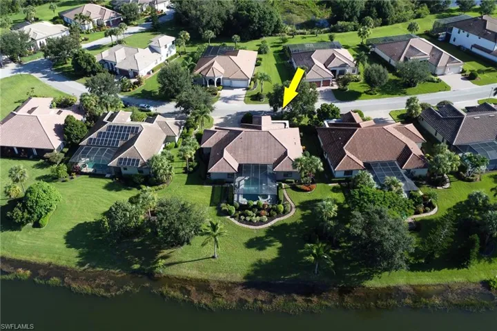 Aerial view of property and surrounding area with nearby suburban area and a large body of water