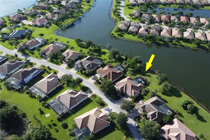 Aerial overview of property's location with nearby suburban area and a large body of water