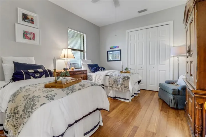 Bedroom featuring a closet, light wood-style floors, and a ceiling fan