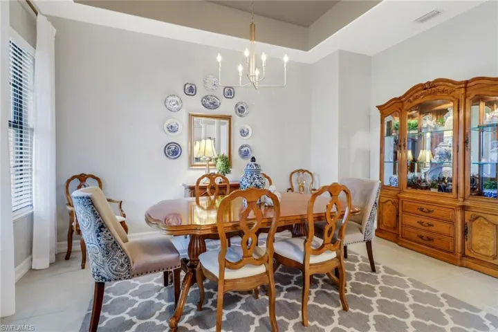 Dining area featuring a chandelier, light tile patterned floors, and plenty of natural light