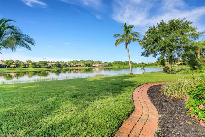 View of grassy yard with a water view