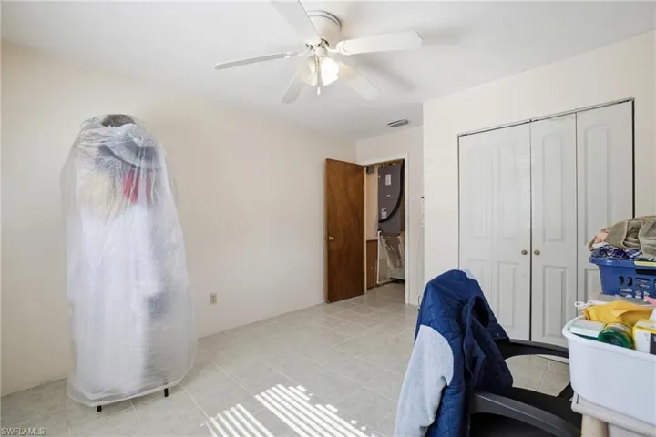 Home office with ceiling fan and light tile patterned floors