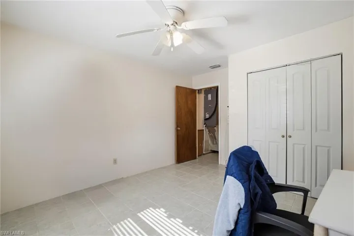 Office area with ceiling fan and light tile patterned floors