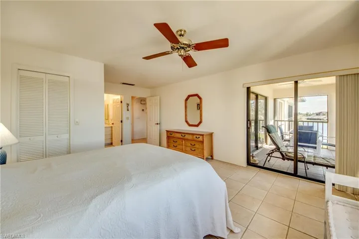 Tiled bedroom featuring access to outside and ceiling fan