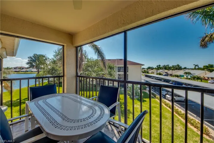 Sunroom featuring a water view