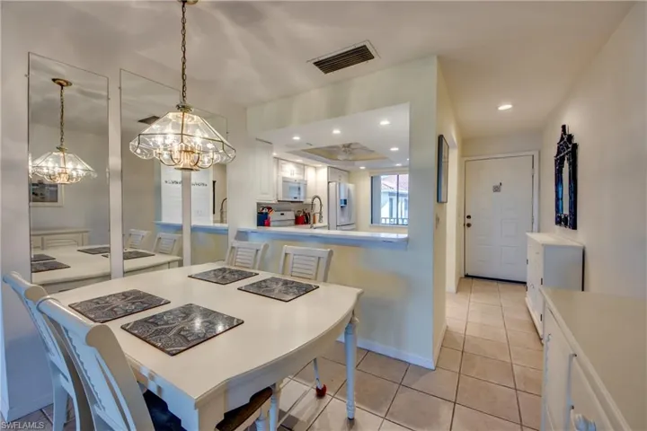 Dining area featuring sink and light tile patterned floors