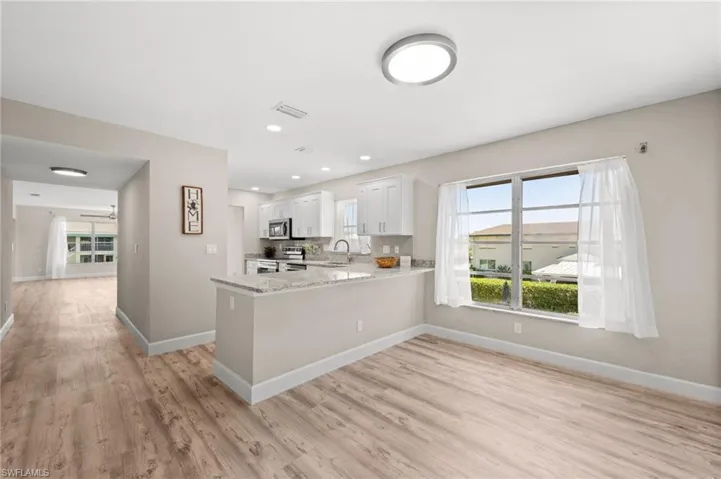 Looking from the breakfast nook to kitchen and living