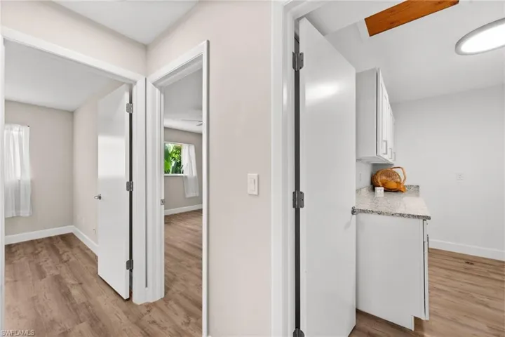 Hallway with access to laundry room and bedroom 2 and bedroom 3