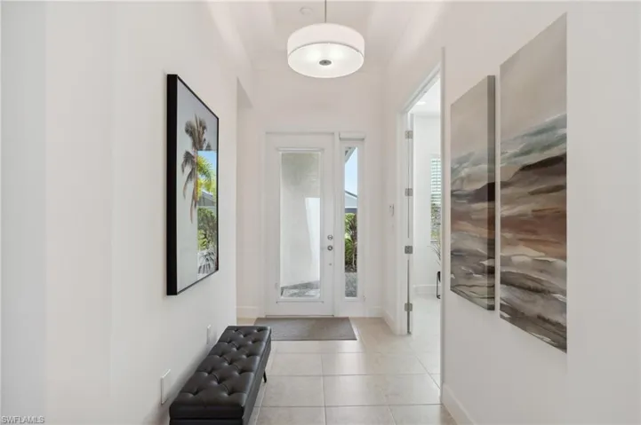 Entrance foyer featuring light tile patterned flooring
