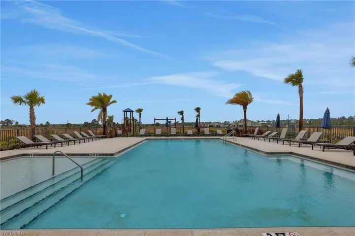 Community pool featuring a patio