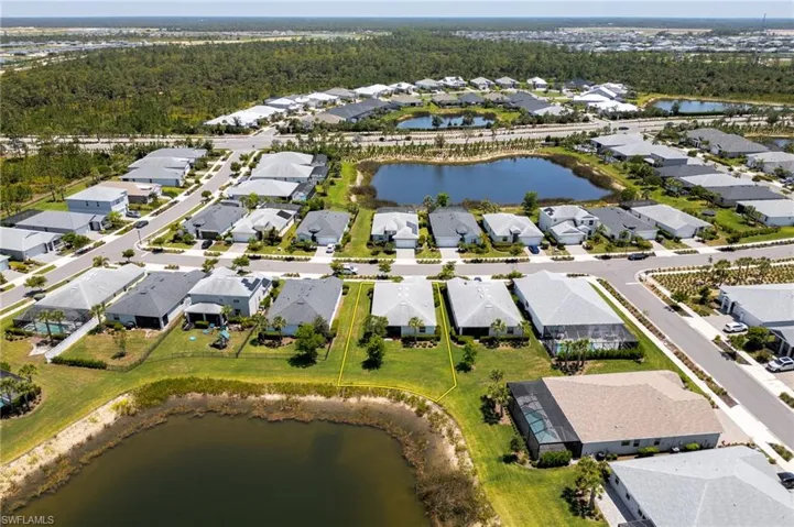 Aerial view of property's location with a large body of water and nearby suburban area