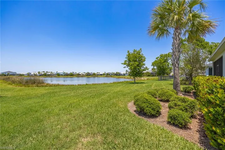 View of green lawn featuring a water view