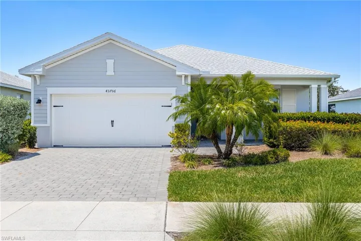 Single story home featuring decorative driveway and an attached garage