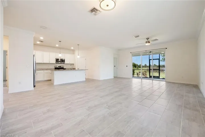 Unfurnished living room featuring crown molding, a ceiling fan, recessed lighting, and baseboards