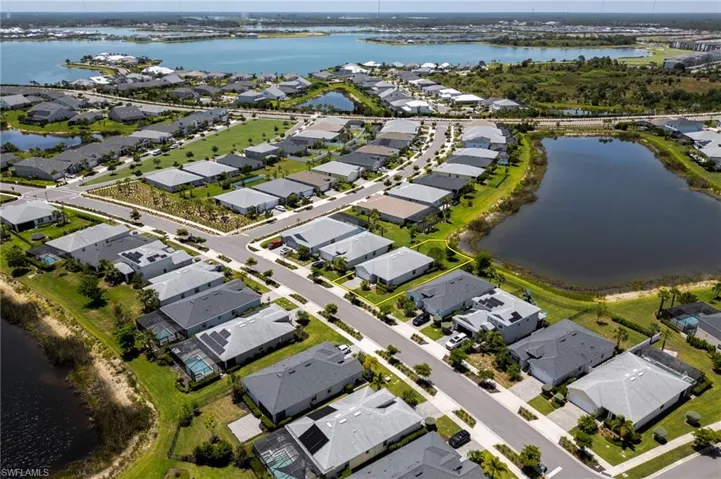 Aerial view of property's location with nearby suburban area and a nearby body of water