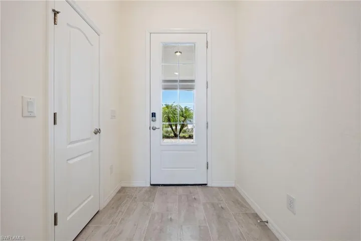 Entryway with baseboards and light wood finished floors